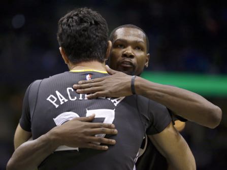 FILE - In this Nov. 19, 2016, file photo, Golden State Warriors' Kevin Durant hugs Zaza Pachulia after the team's NBA basketball game against the Milwaukee Bucks in Milwaukee. With all that was made before the season about adding Kevin Durant to an already star-studded roster, Golden State's players have jelled just fine. (AP Photo/Aaron Gash, File)