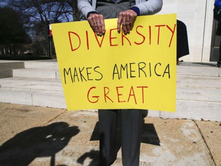 Professor Fran O'Neal holds a sign during a gathering at the University of Alabama in Tuscaloosa, Ala., to support an open campus and oppose the travel ban imposed by President Donald Trump Thursday, Feb.9, 2017. (AP Photo/Gary Cosby Jr., Tuscaloosa News) (Gary Cosby Jr./The Tuscaloosa News via AP)