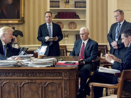 FILE - In this Jan. 28, 2017 file photo, President Donald Trump accompanied by, from second from left, Chief of Staff Reince Priebus, Vice President Mike Pence, White House press secretary Sean Spicer and then-National Security Adviser Michael Flynn speaks on the phone with Russian President Vladimir Putin, in the Oval Office at the White House in Washington. Trump's White House is nearly paralyzed by crisis, divisions and dysfunction. Virtually all policy announcements have slowed to a crawl. Aides are undercutting each other in leaks (AP Photo/Andrew Harnik, File)