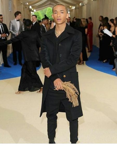 Jaden Smith and yes, those are his locs in his hand…