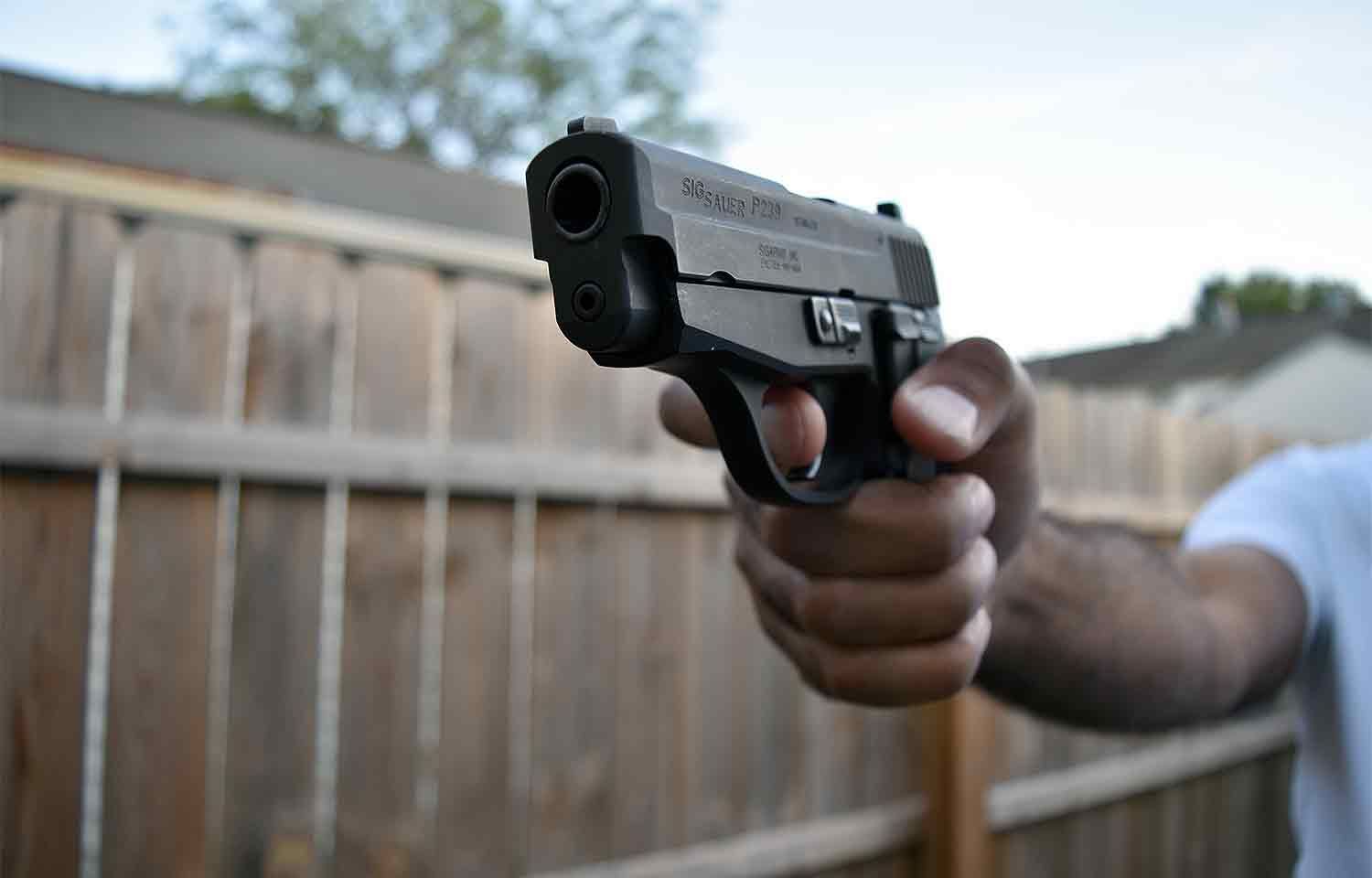 Man holding handgun pistol