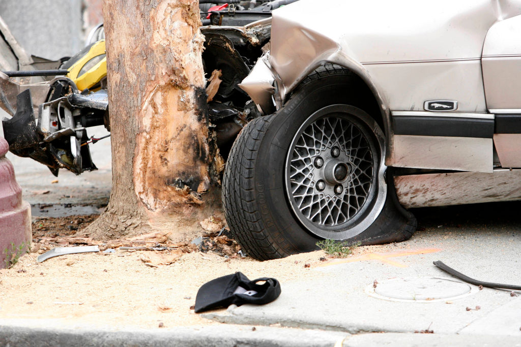 A baseball hat lies on the ground near the wheel of the car which caused an accident on Mission Street where one pedestrian was fatally injured when hit by the vehicle on Monday, September 29, 2008 in San Francisco, Calif.