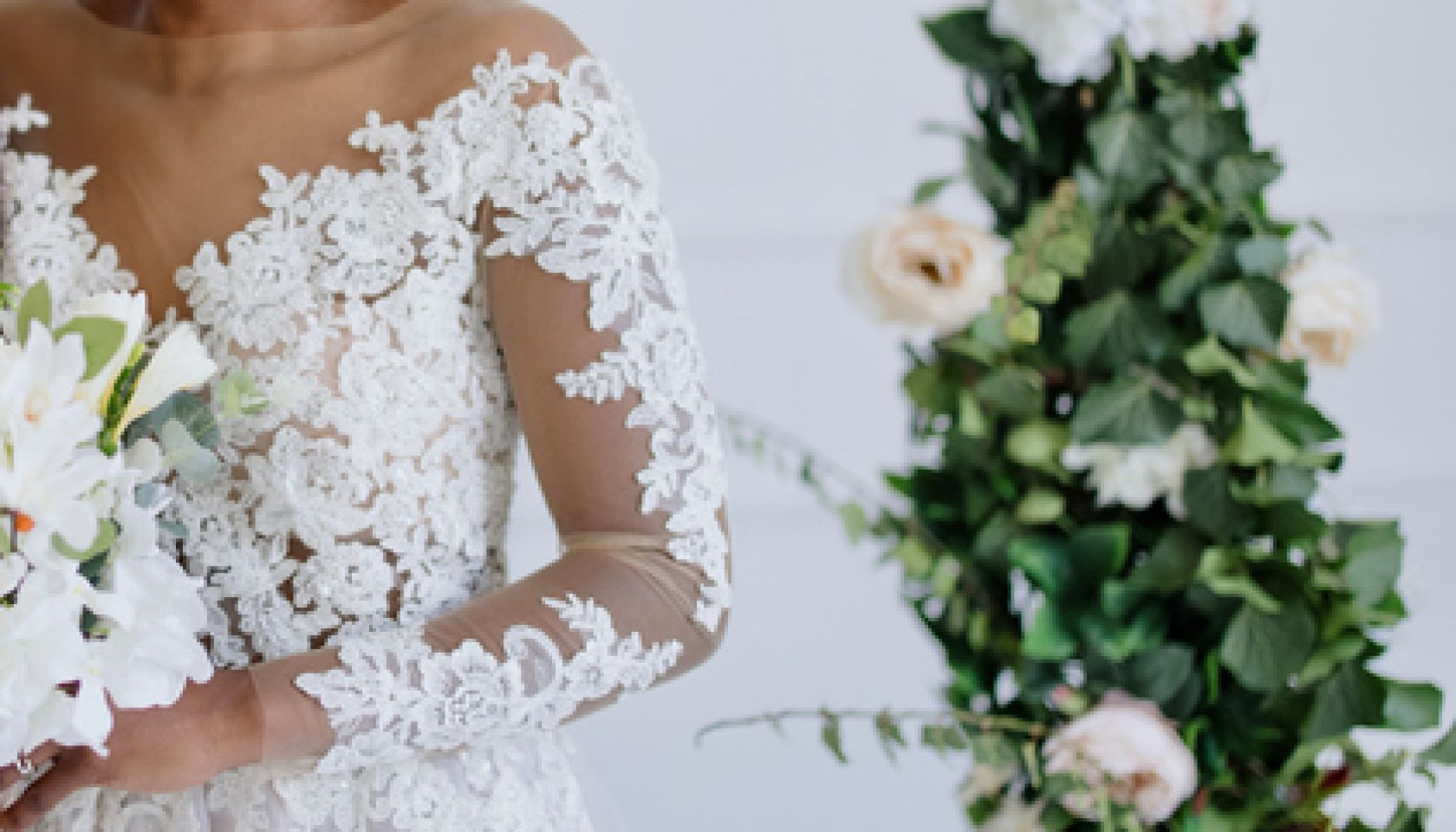 Portrait of newlyweds, groom and bride embracing near altar