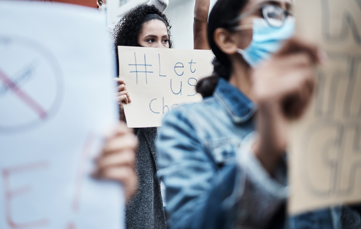 Shot of a group of people marching at a corona virus vaccine protest