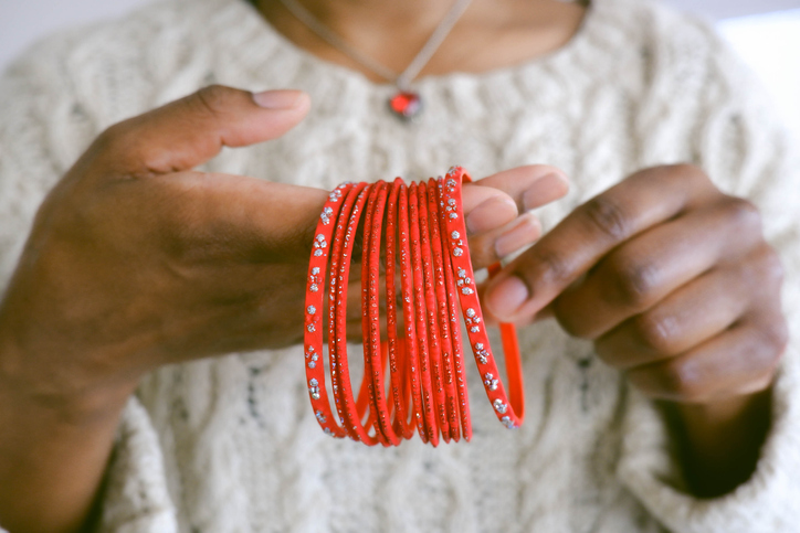 Woman Holds Red Bangles