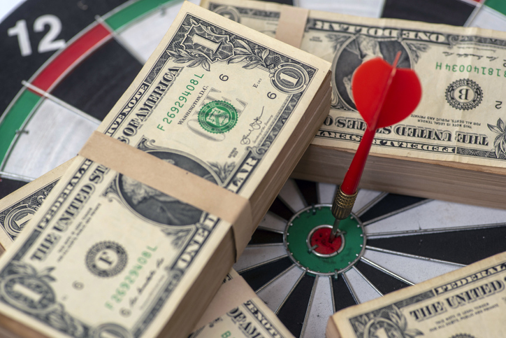 Red dart arrow hit the centre target of dartboard and money coin metaphor marketing