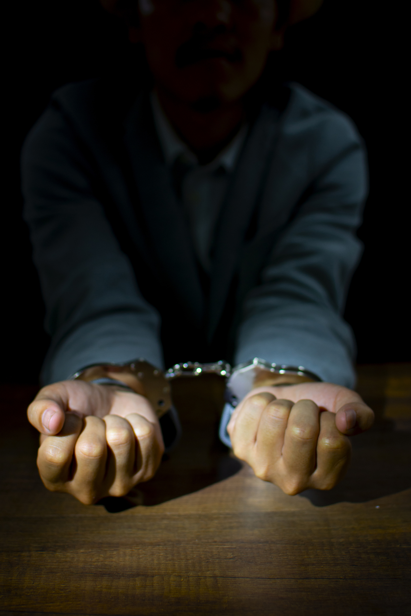 Upset handcuffed man imprisoned for financial crime, punished for serious fraud