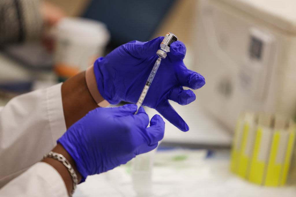 Medical professional prepares Covid-19 booster shot