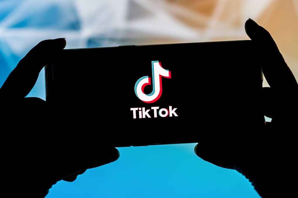 In this photo illustration a TikTok logo seen displayed on a...
