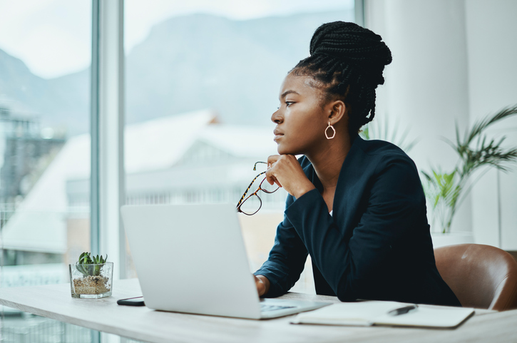 Shot of a young businesswoman using a laptop in a modern office