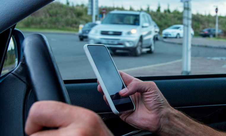 Car driver using mobile phone.