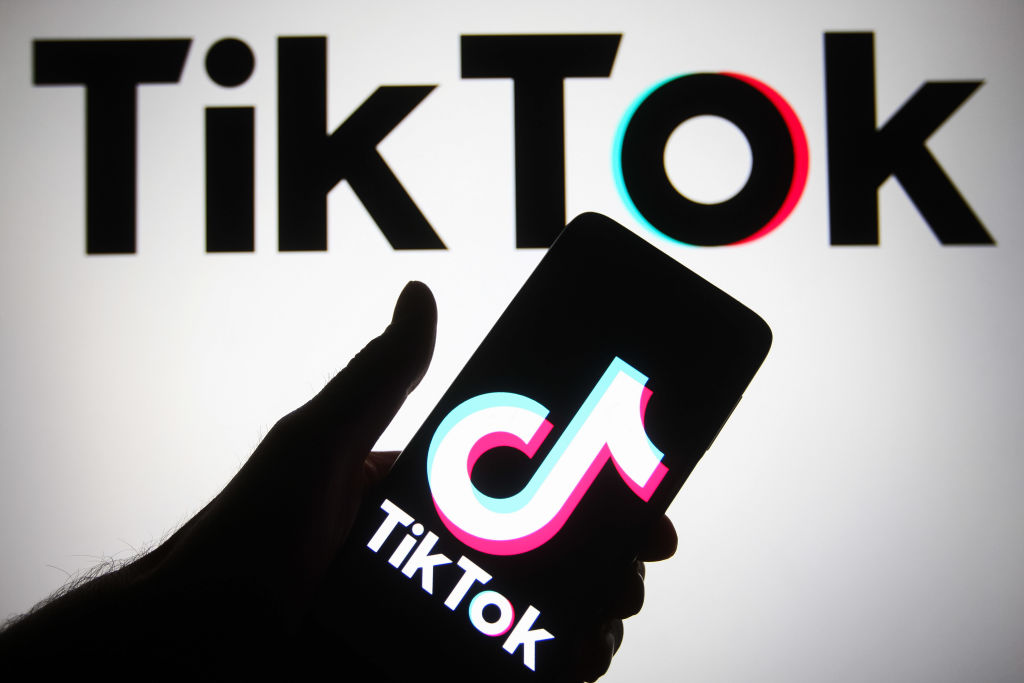 In this photo illustration, TikTok logo is seen displayed on...