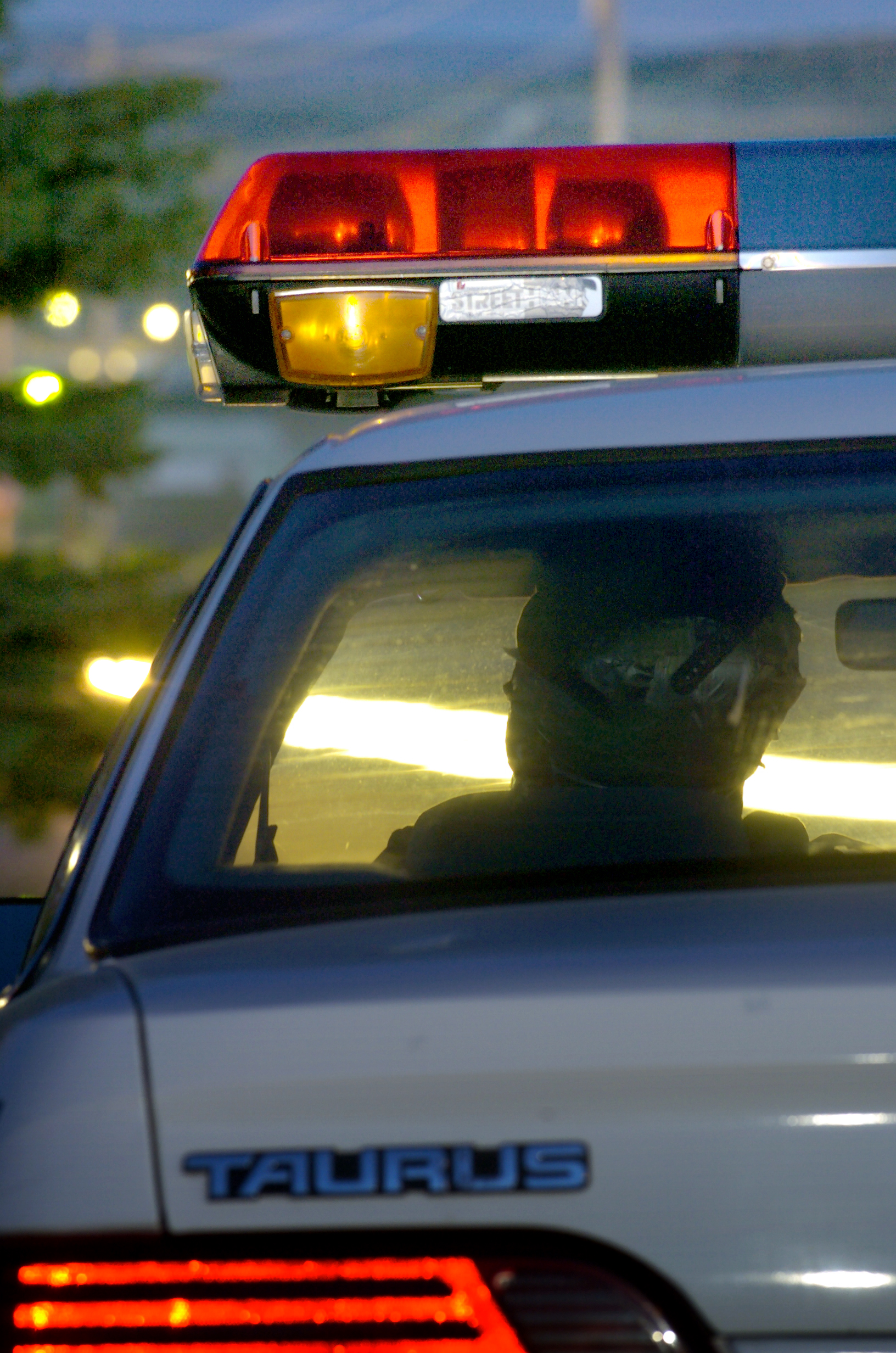 ROCK SPRINGS, WYO. - JUNE 9. 2005 - The well-known "dummy cop", a uniformed mannequin in an old patrol car, appears to keep an eye on traffic near new housing developemnts in Rock Springs, Wyo. Thursday evening, 6/9/05. Rocks Springs is undergoing a boom