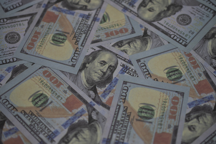 Lots of US Dollar bank notes as for financial business background.