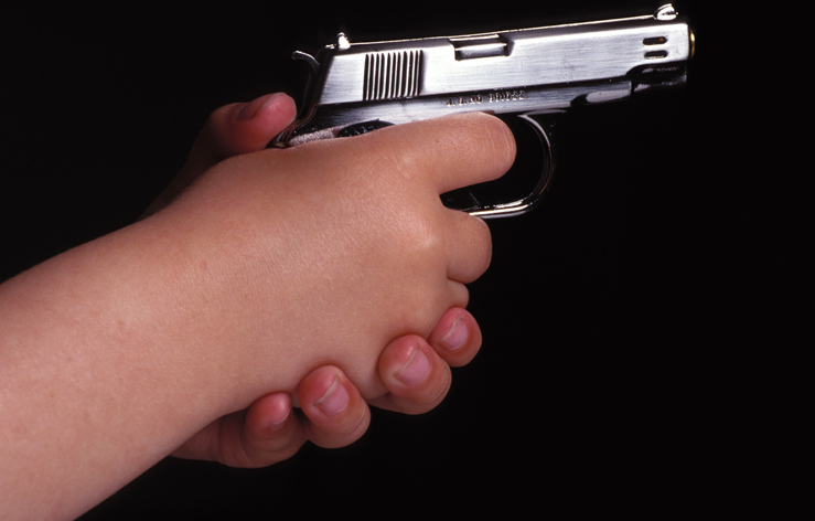 Kids Hands Holding a Gun