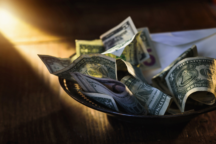 Close up of banknotes on collection plate