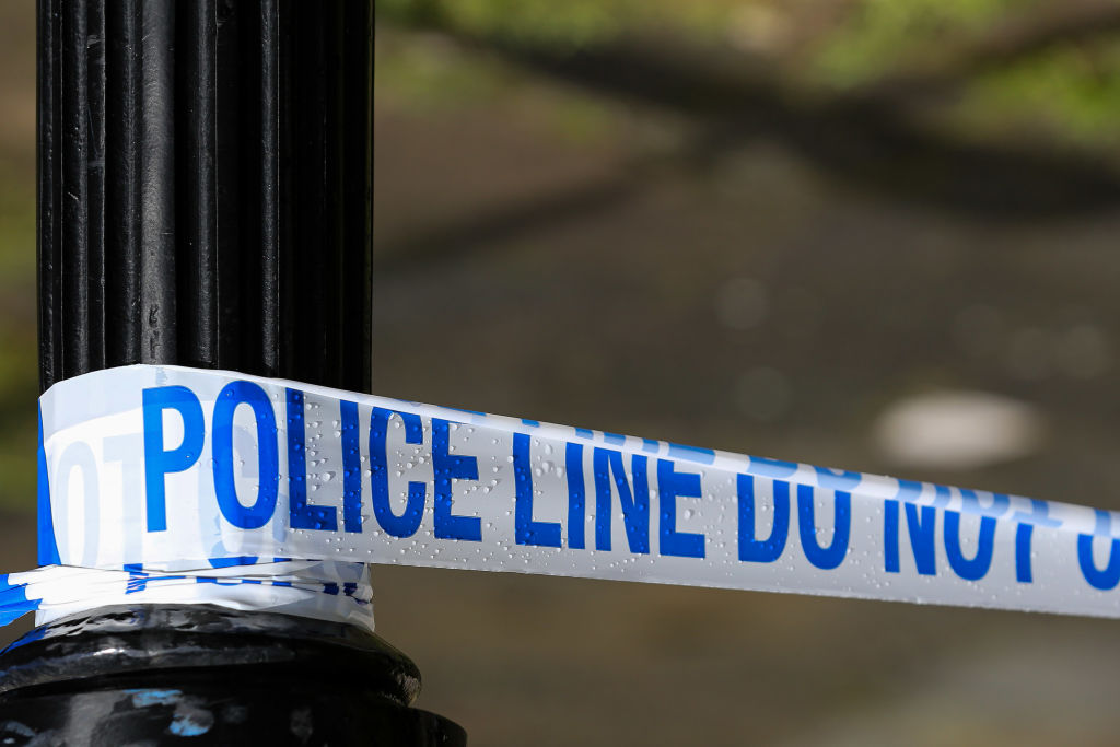 A police tape cordons off a crime scene...