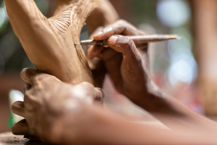 Female sculptor working in her art studio
