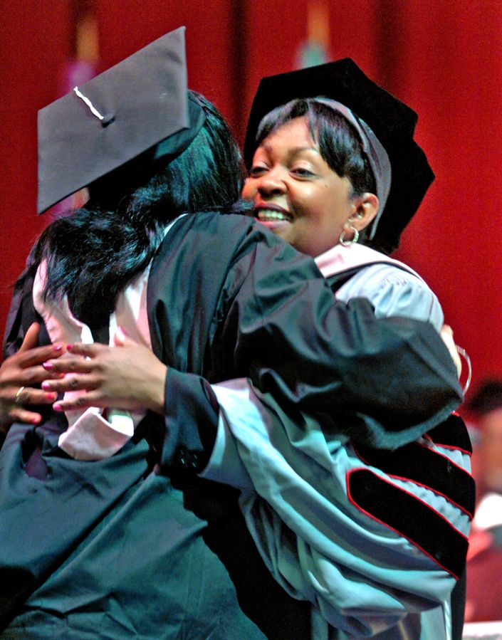 (050705 - BOSTON, MA) Berklee College of Music Honorary Degree recipient Anita Baker, right, gets a hug from graduate Natalie Fernandez of Miami Florida upon rceieving her diploma at the school's commencement ceremonies at Northeastern's Matthews Are