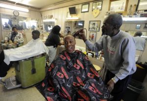SOUTHERNPOL16 -- Vernon Winfrey, right, cuts hair on Roland Jones at a barbershop, that is owned by Vernon who is the father of Oprah Winfrey, in Nashville, Tennessee. The barbershop is a popular place for men in the neighborhood to hangout and talk polit