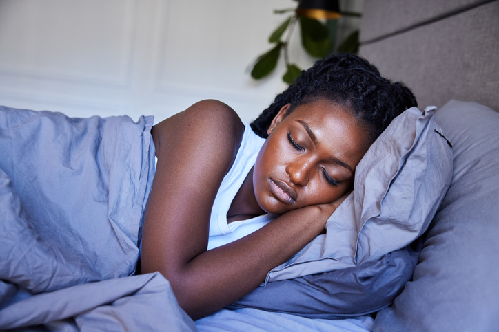 Young woman sleeping in her bed in the morning