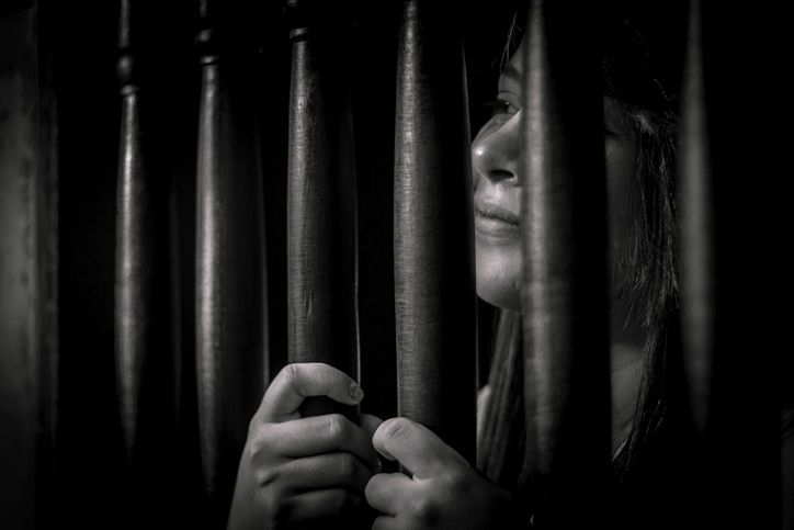 Woman Behind Prison Bars