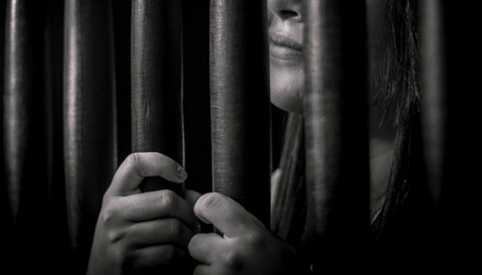 Woman Behind Prison Bars