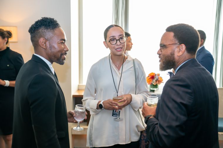 Dr. Logan Hampton in conversation with media attendees