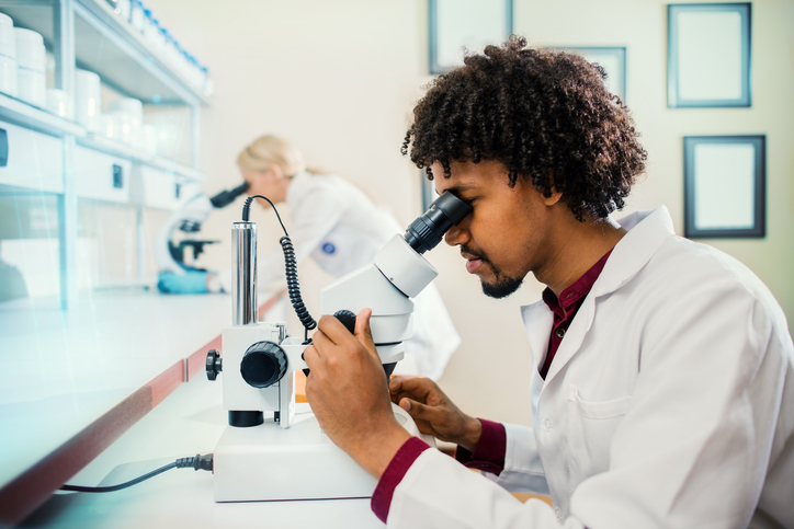 Scientist Using Microscope in Laboratory