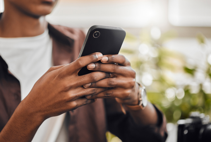 Phone, internet and communication with man hands typing on social media, doing internet search or messaging app. Zoom in on 5g technology network with male networking to connect or a reading text