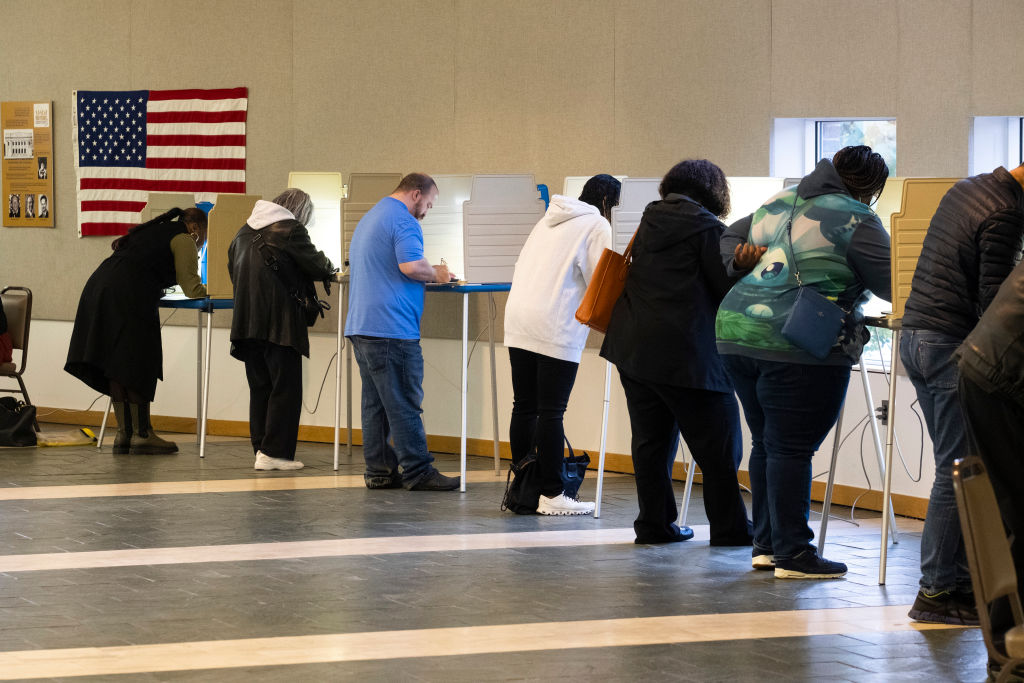 Voters cast their ballots at a polling station in Detroit...