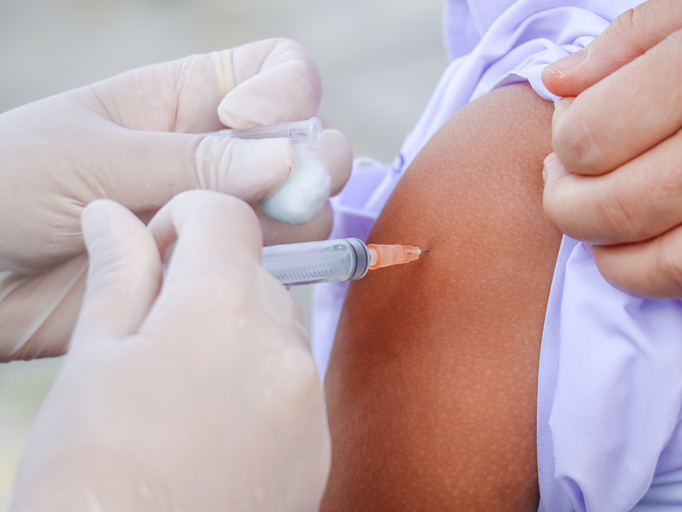 children's coronavirus vaccine sit vaccinated with syringe against covid-19