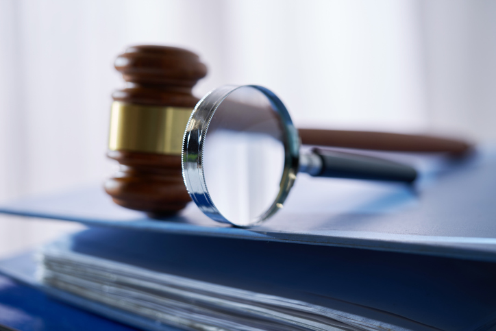 Magnifying glass gavel hammer on stack of document,Malaysia