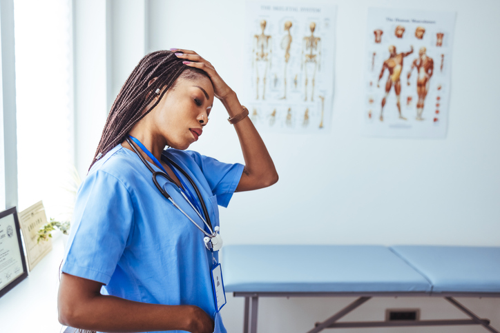 Female nurse suffering from headache