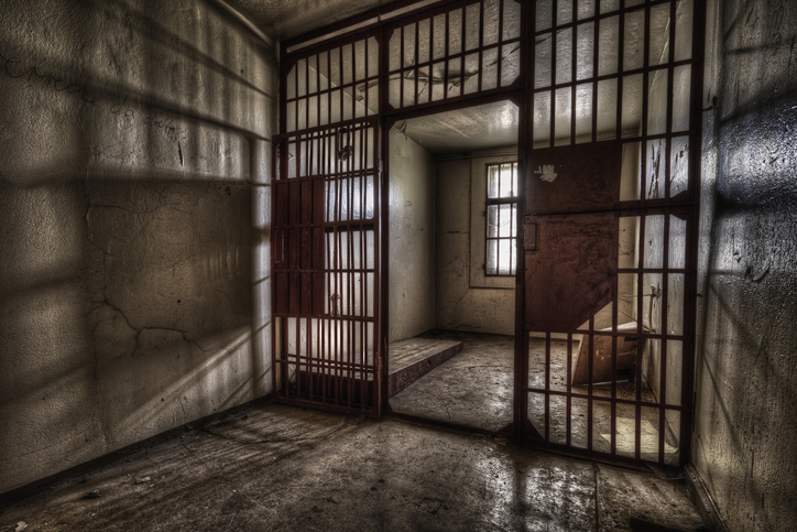 Shot of a prison cell with a lattice door