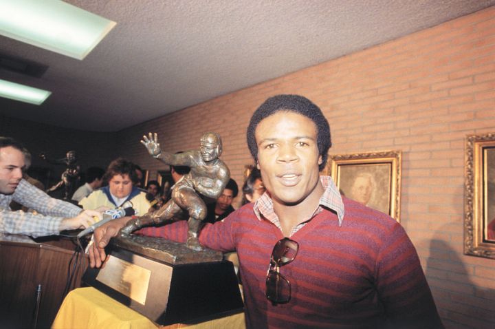 Charles White Posing with Heisman Trophy