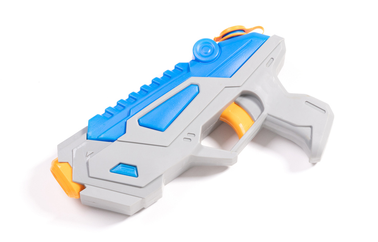 Modern small water pistol isolated on white