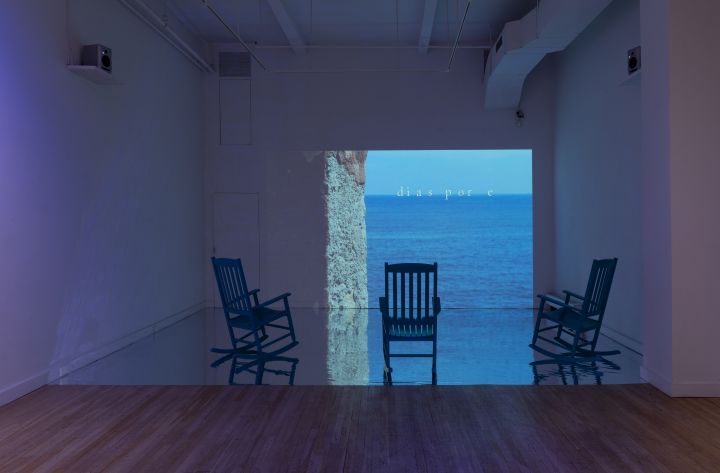 Miatta Kawinzi, 'SHE GATHER ME,' 2021, HD color video & 16 mm color film transferred to video with two - channel audio, three wooden rocking chairs, silver mylar floor, dimensions variable. Installation view at CUE Art Foundation, NYC.