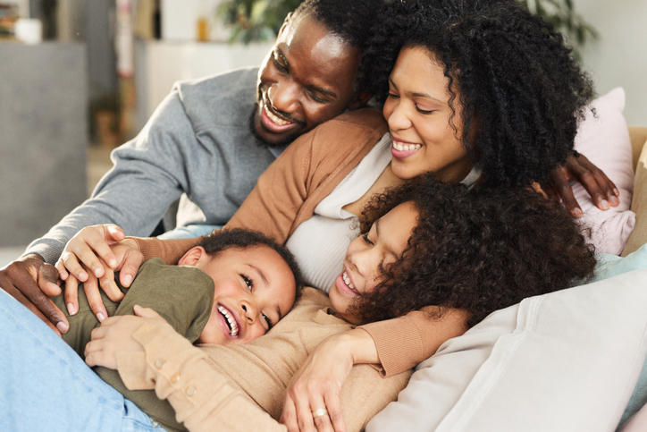 Loving African American family relaxing at home.