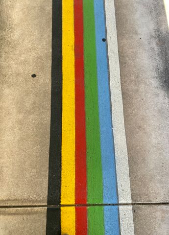 Colourful lines painted on the side walk.