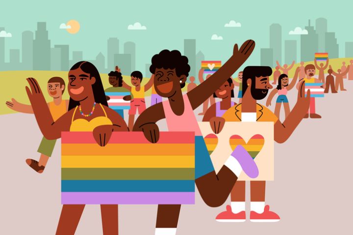 A Multiracial LGBTQIA Group Holds Pride Flags and Smiles While Walking in Pride Parade