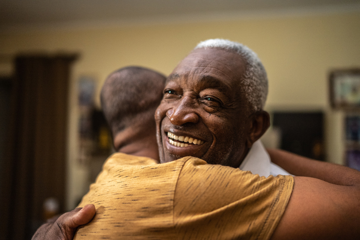 Bonding moment of father and son embracing at home