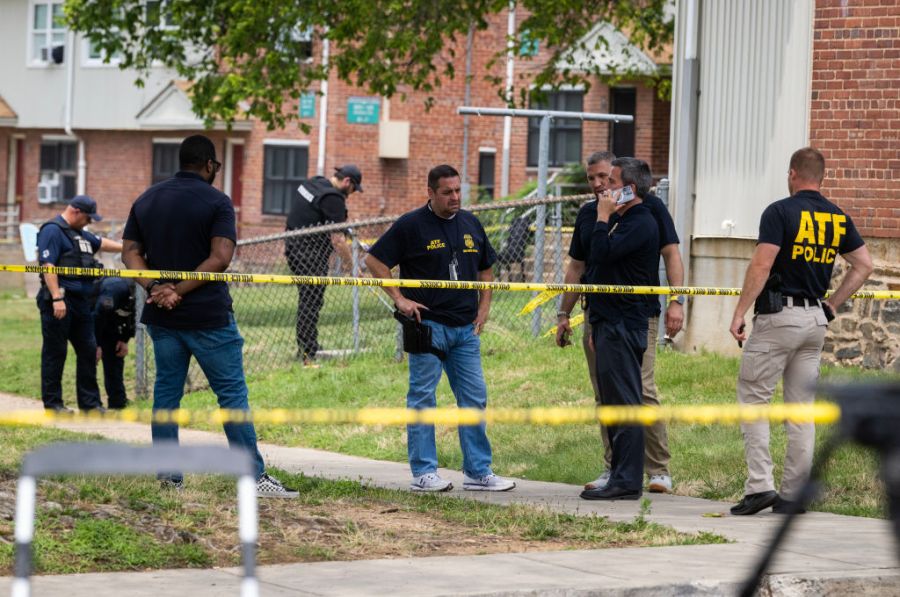 Authorities search for evidence at the scene of last nights mass shooting that left 2 dead and 20 wounded, on July 02 in Baltimore, MD.