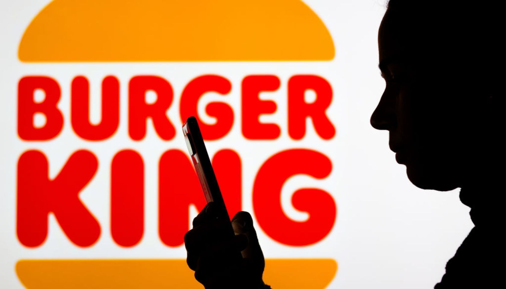 In this photo illustration the Burger King logo seen in the...