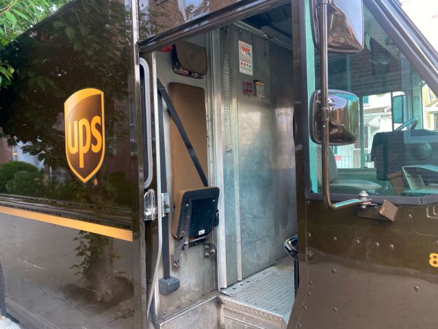 UPS truck interior parked in residential neighborhood, Queens, New York