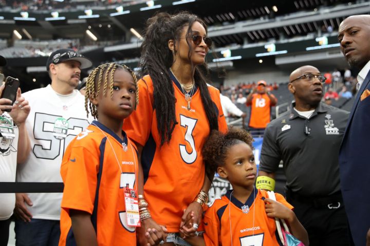 Future Zahir Wilburn, Ciara Wilson, wife of Russell Wilson #3 of the Denver Broncos, and Sienna Princess Wilson look on from the field before the game between the Denver Broncos and Las Vegas Raiders
