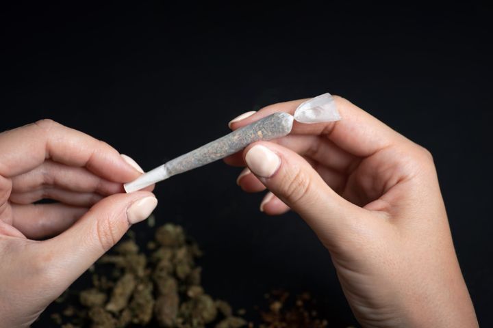 Woman rolling a marijuana joint