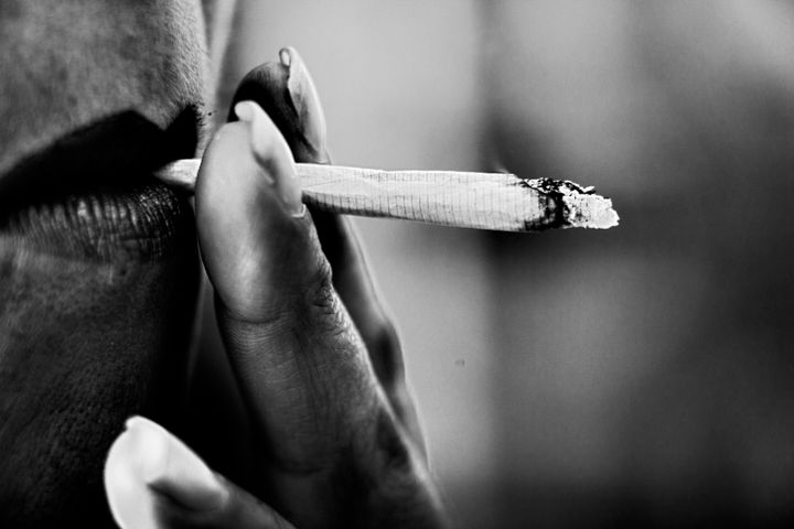 Woman smokes a rolled joint