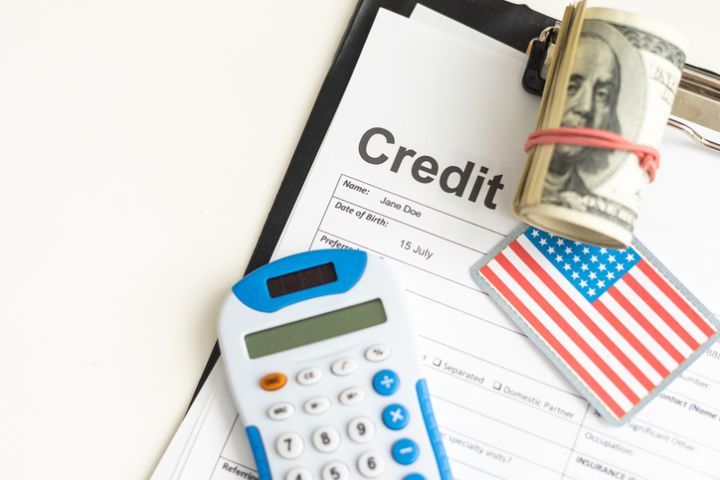 Tax Return form 1040 with credit card and USA flag : U.S. Individual Income.