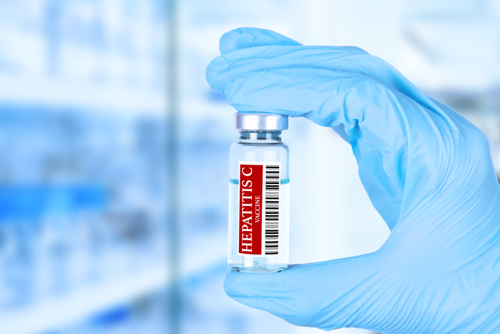 Hepatitis C vaccine. medical ampoule in the hands of a doctor. Vaccination awareness concept. Toned image. Soft blurred background. Medical poster.